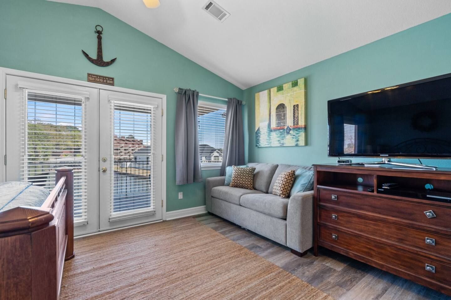 A living room with a couch and a flat screen tv.