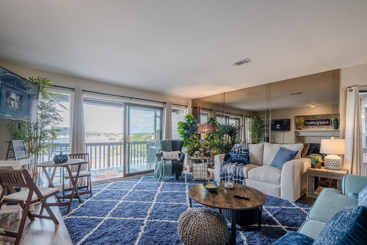 A living room filled with furniture and a blue rug.
