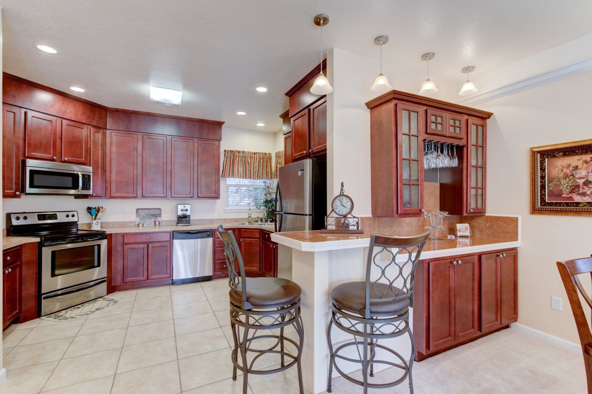A kitchen with wooden cabinets and stainless steel appliances