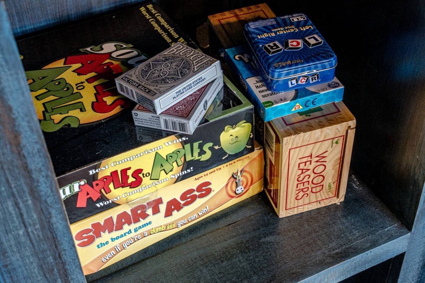 stack of board games in shelf