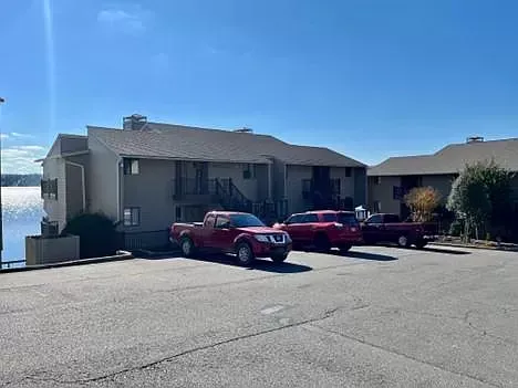 A row of red trucks are parked in front of a building.