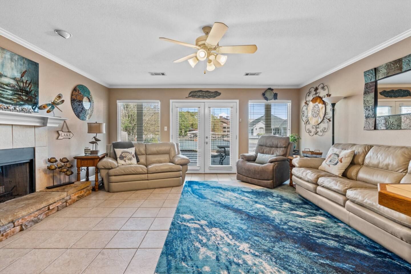 A living room filled with furniture and a ceiling fan.