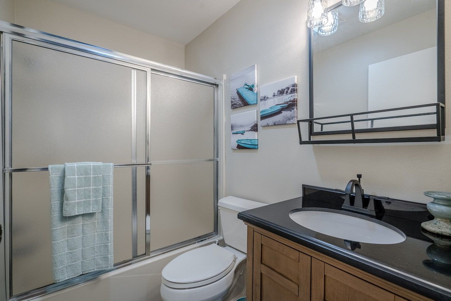 A bathroom with a toilet , sink , and shower.