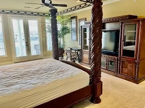 There is a four poster bed in the middle of the room.