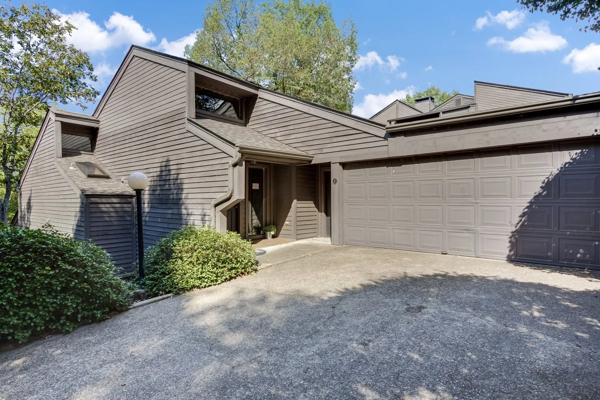 The front of a house with a garage and a driveway.