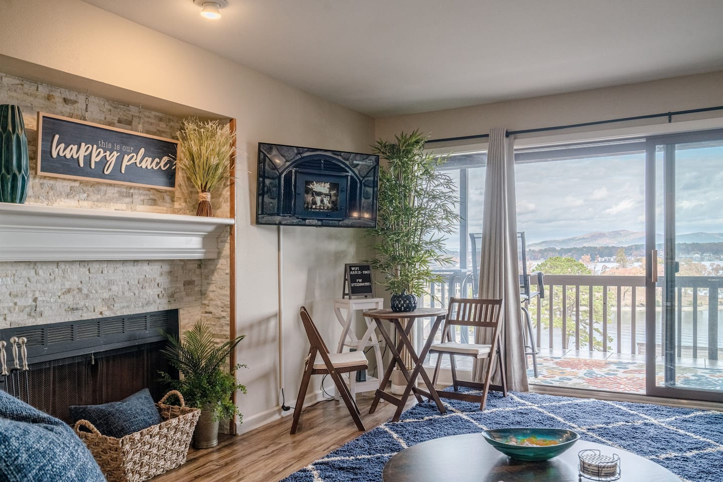 A living room with a fireplace , table and chairs.