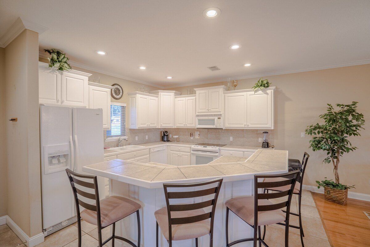 A kitchen with a large island and stools