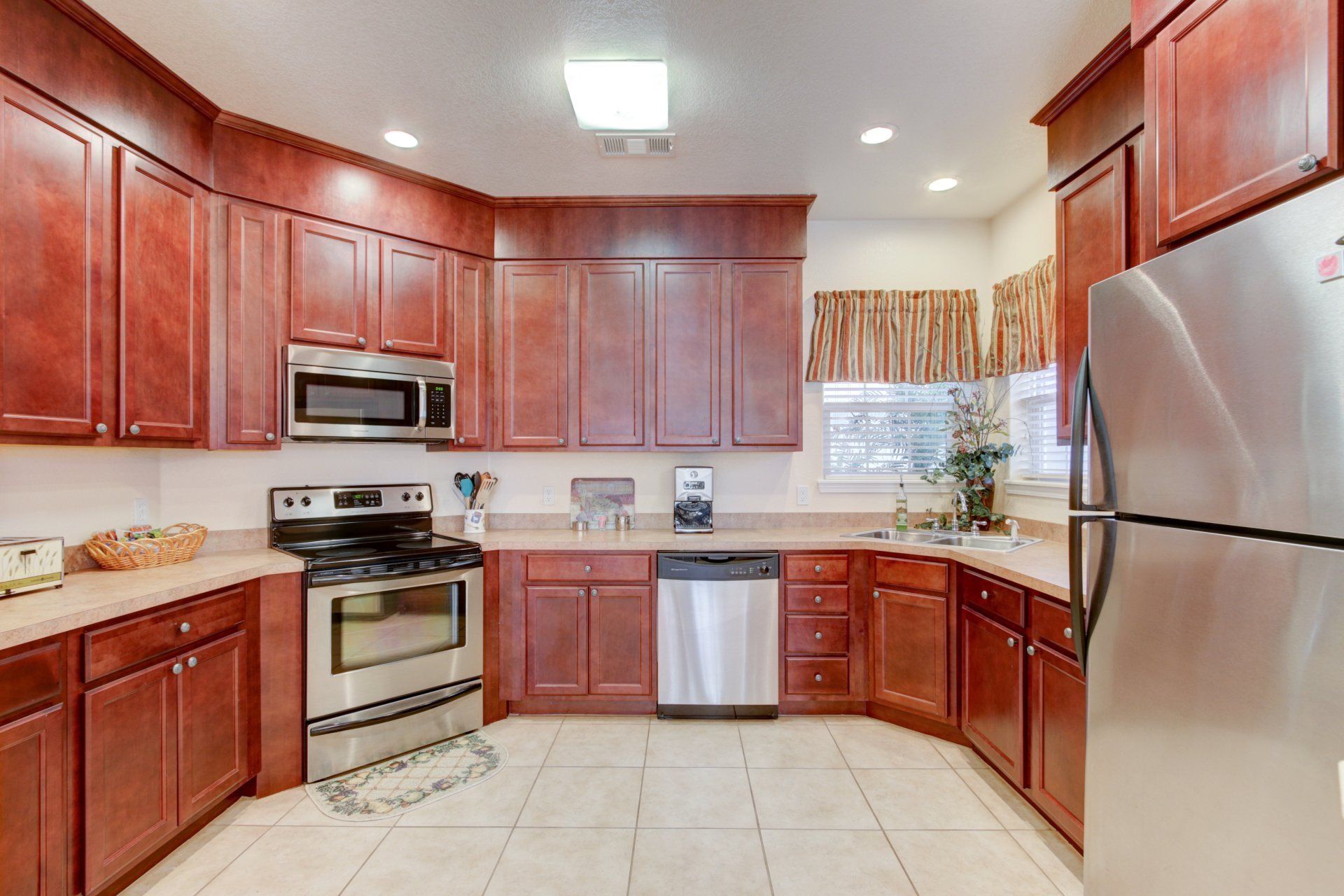 A kitchen with stainless steel appliances and wooden cabinets