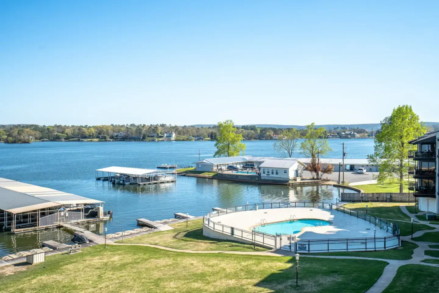 An aerial view of a lake with a swimming pool in the middle of it.
