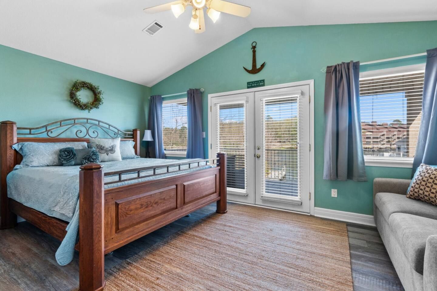 A bedroom with a king size bed and a couch.