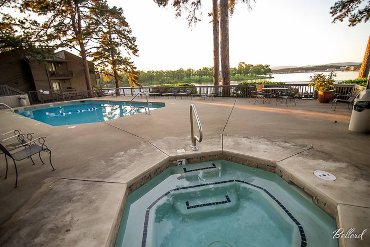 A hot tub is next to a large swimming pool.