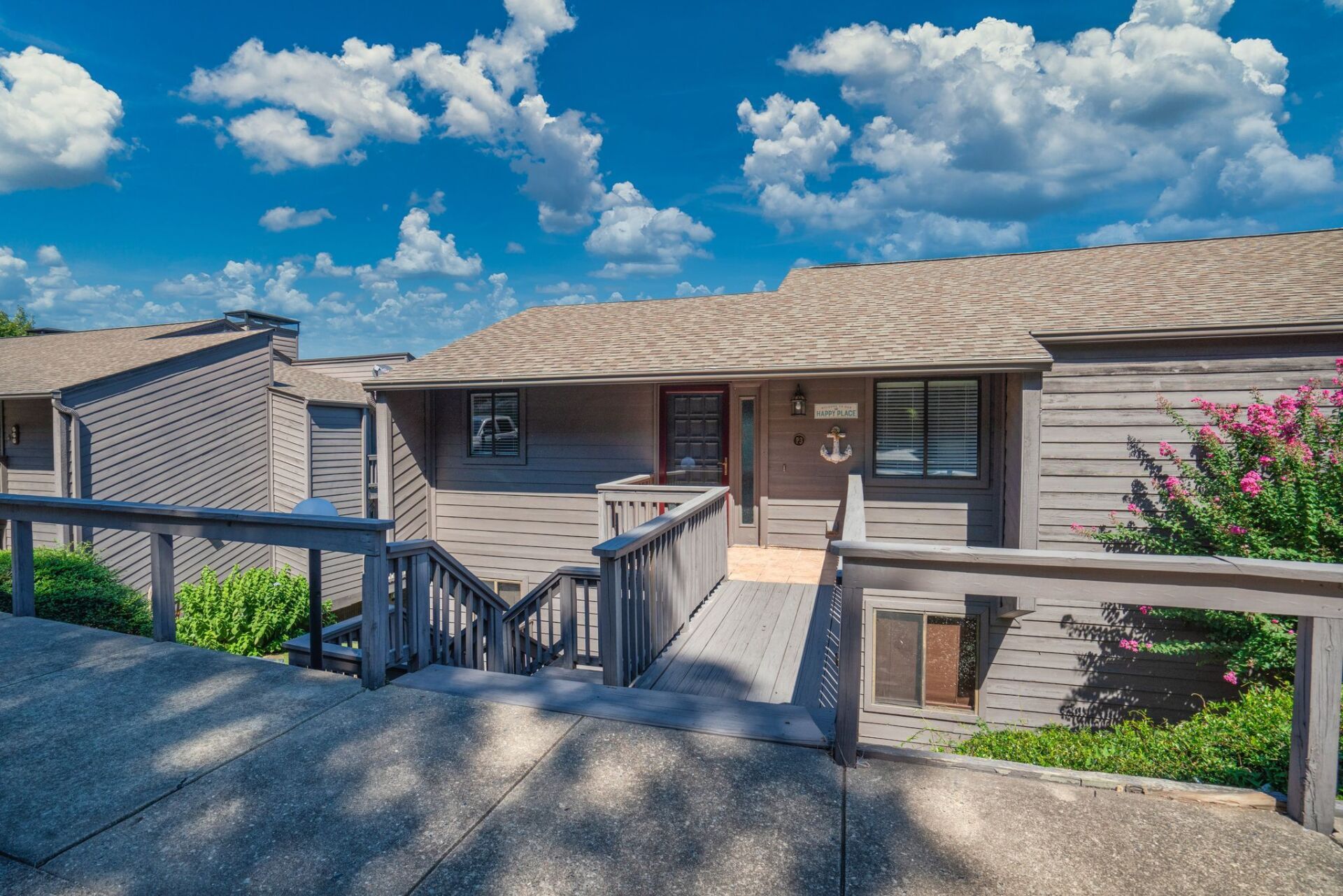 A house with a ramp and stairs leading up to it.