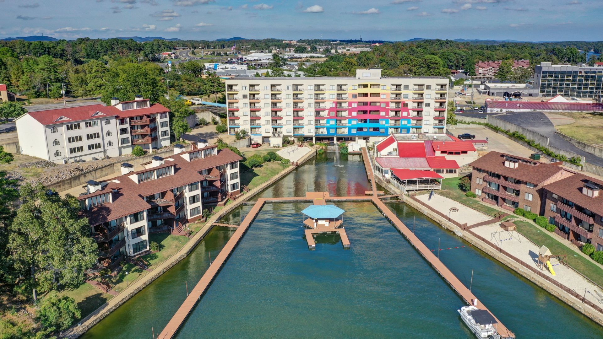 An aerial view of a large body of water surrounded by buildings and trees.