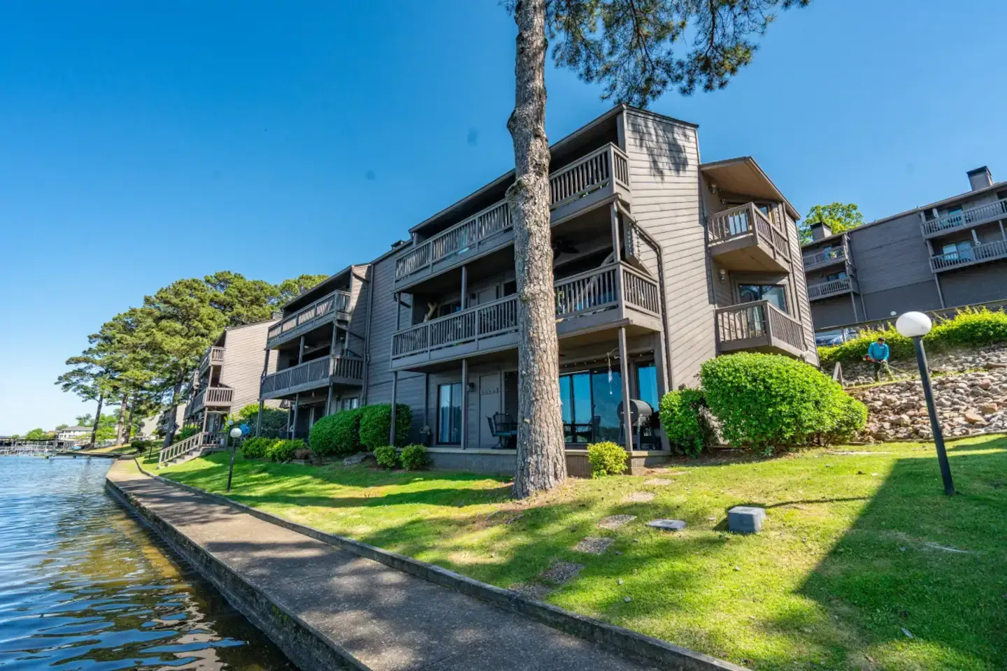 A large apartment building next to a body of water.