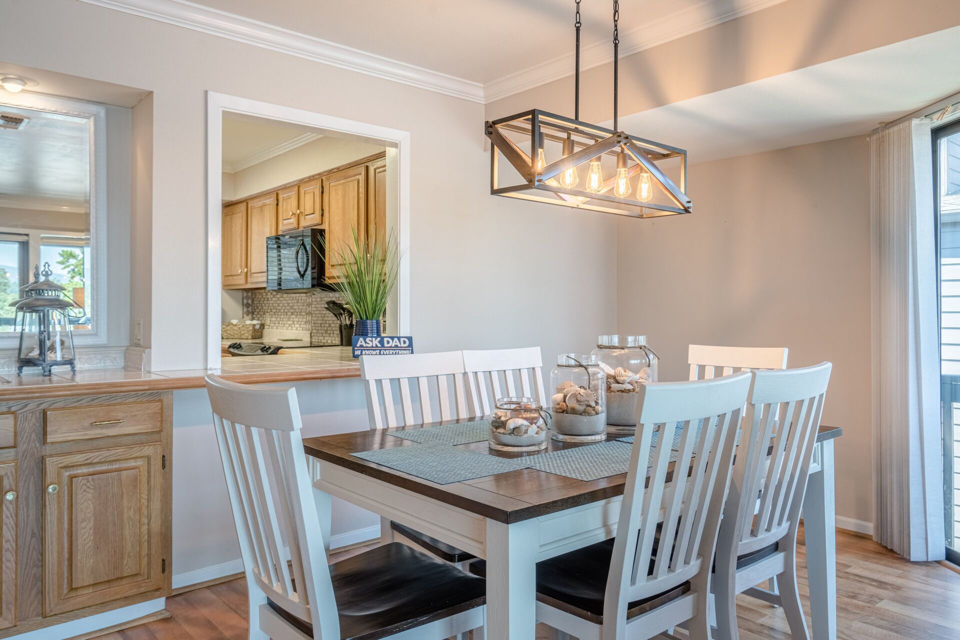 A dining room with a table and chairs and a chandelier.