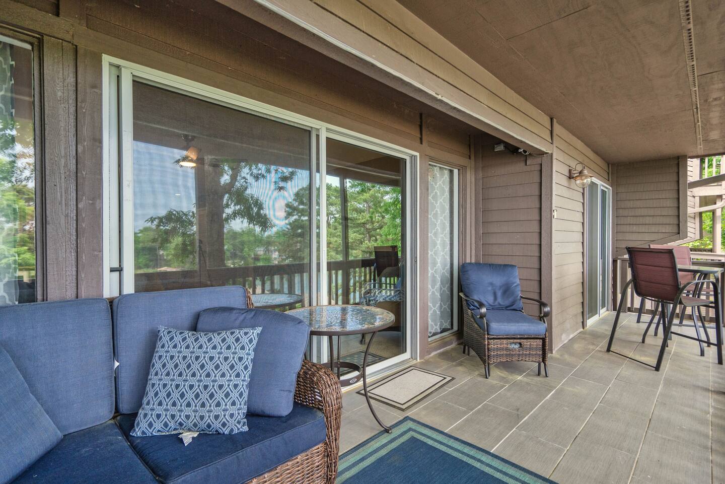 A patio with a couch and chairs and a table