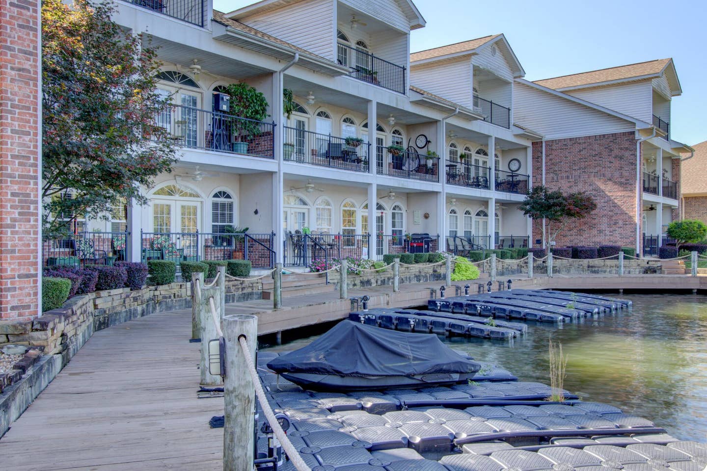 A jet ski is docked on a dock in front of a building.