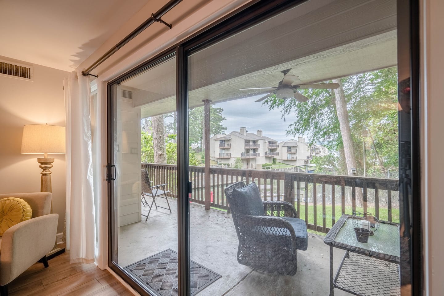 A living room with a sliding glass door leading to a balcony.