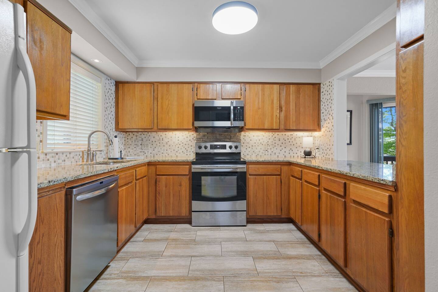 A kitchen with stainless steel appliances and wooden cabinets