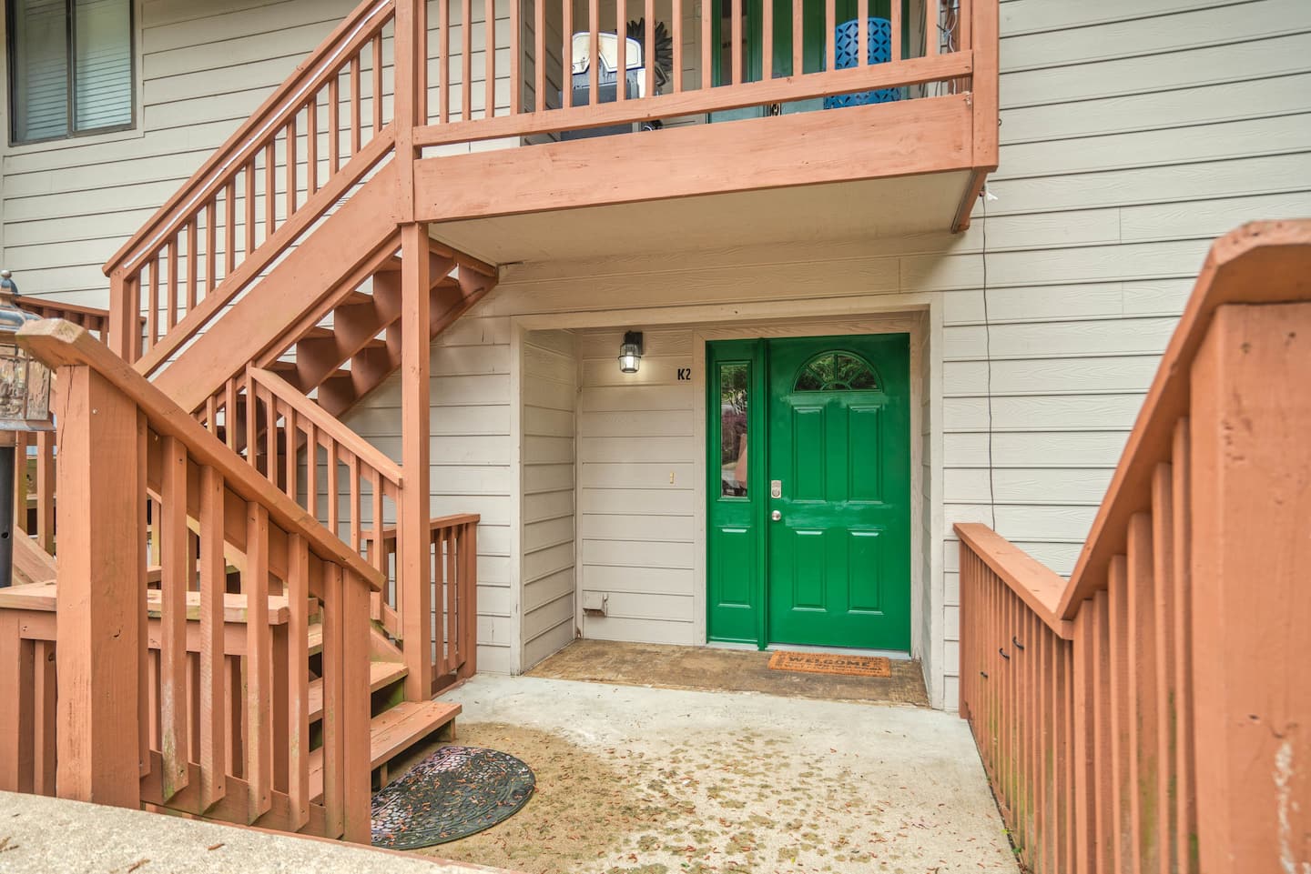 A house with a green door and stairs leading up to it