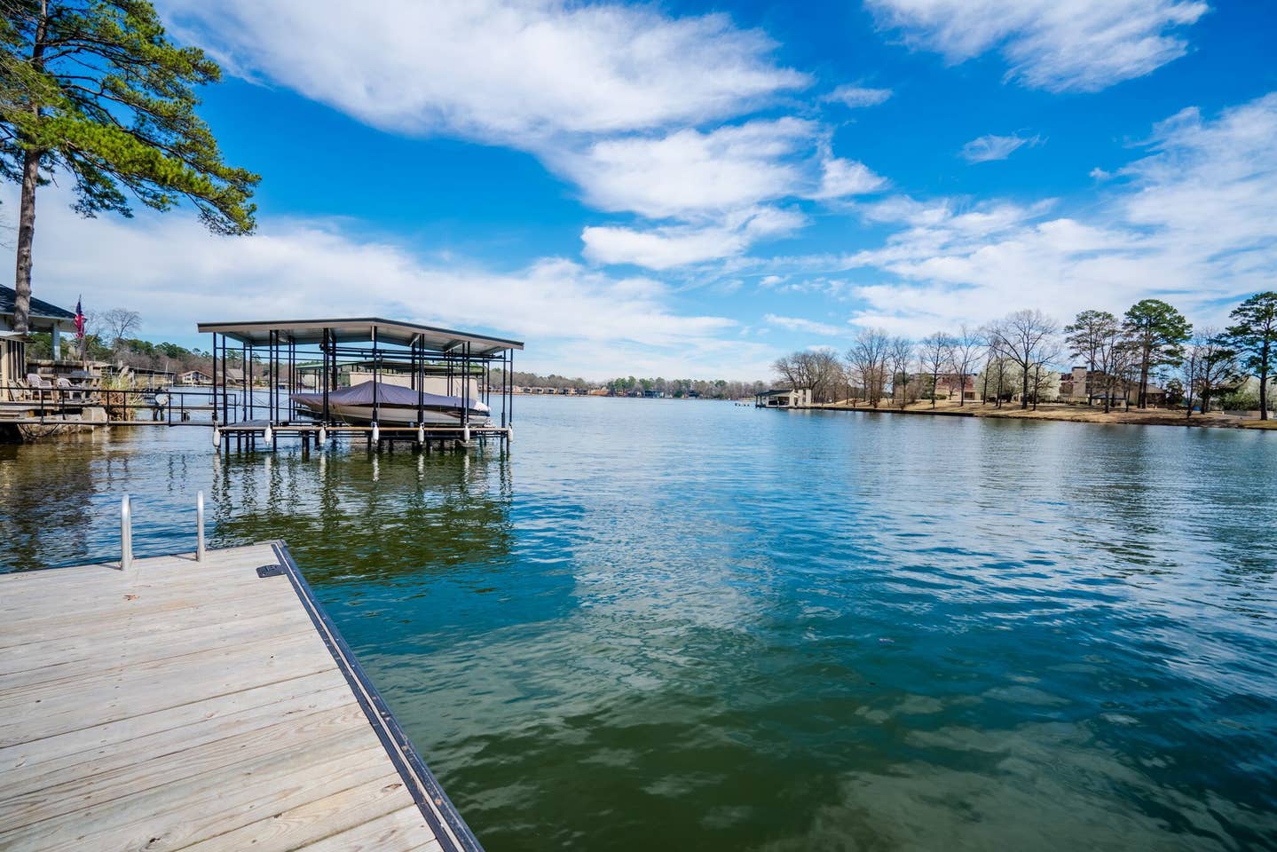There is a dock with a boat docked in the water.
