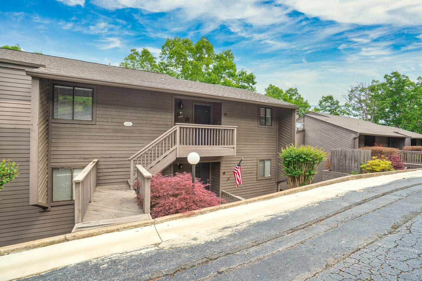 A large apartment building with stairs leading up to the second floor.