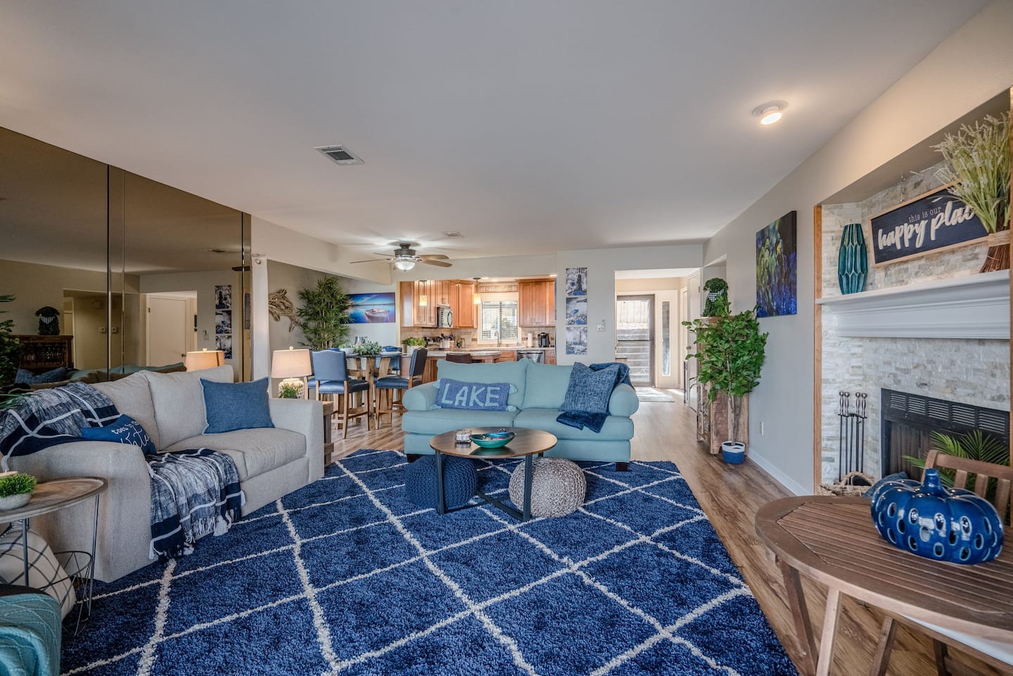 A living room filled with furniture and a blue rug.