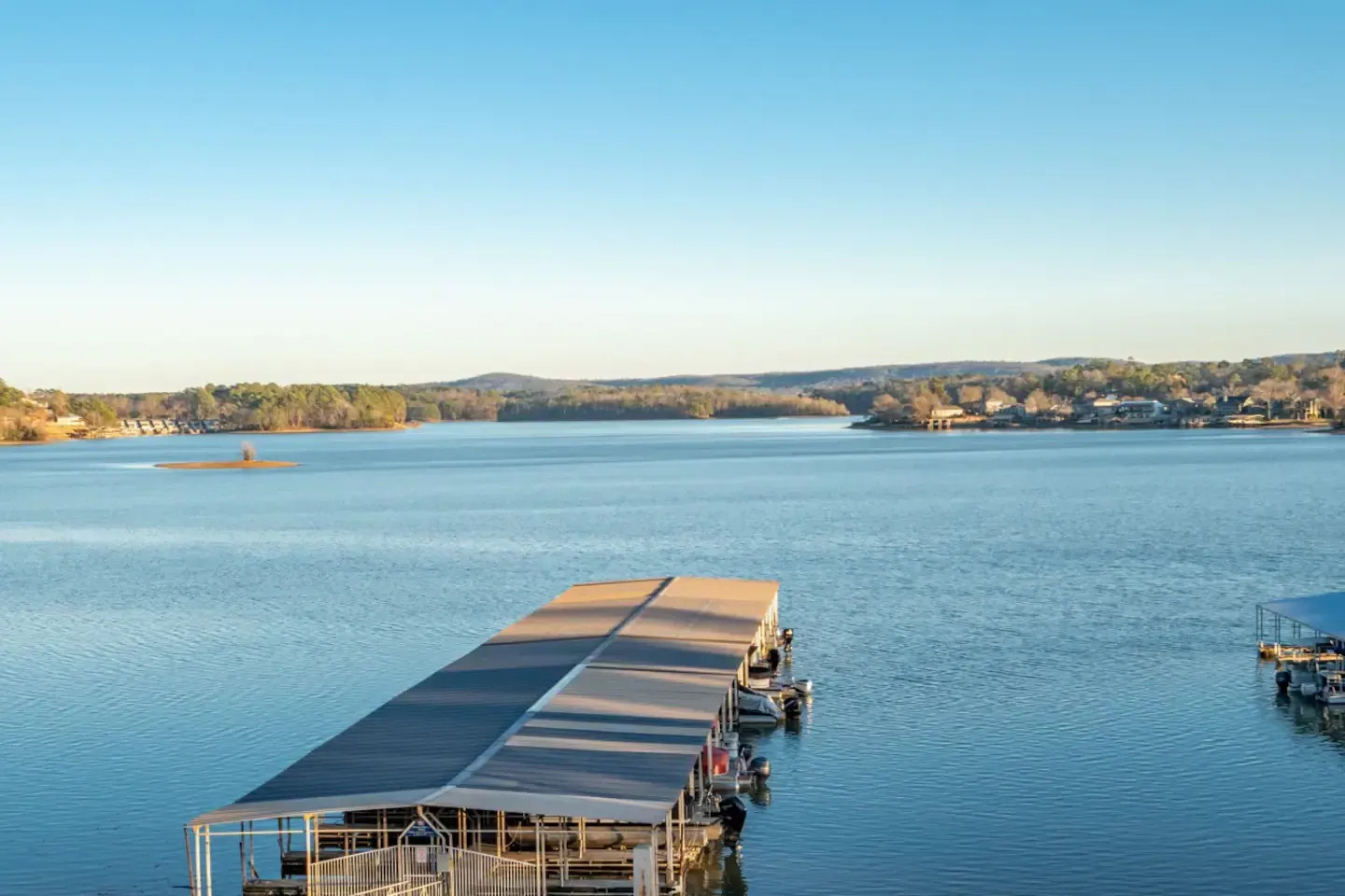A large body of water with a dock in the middle of it.