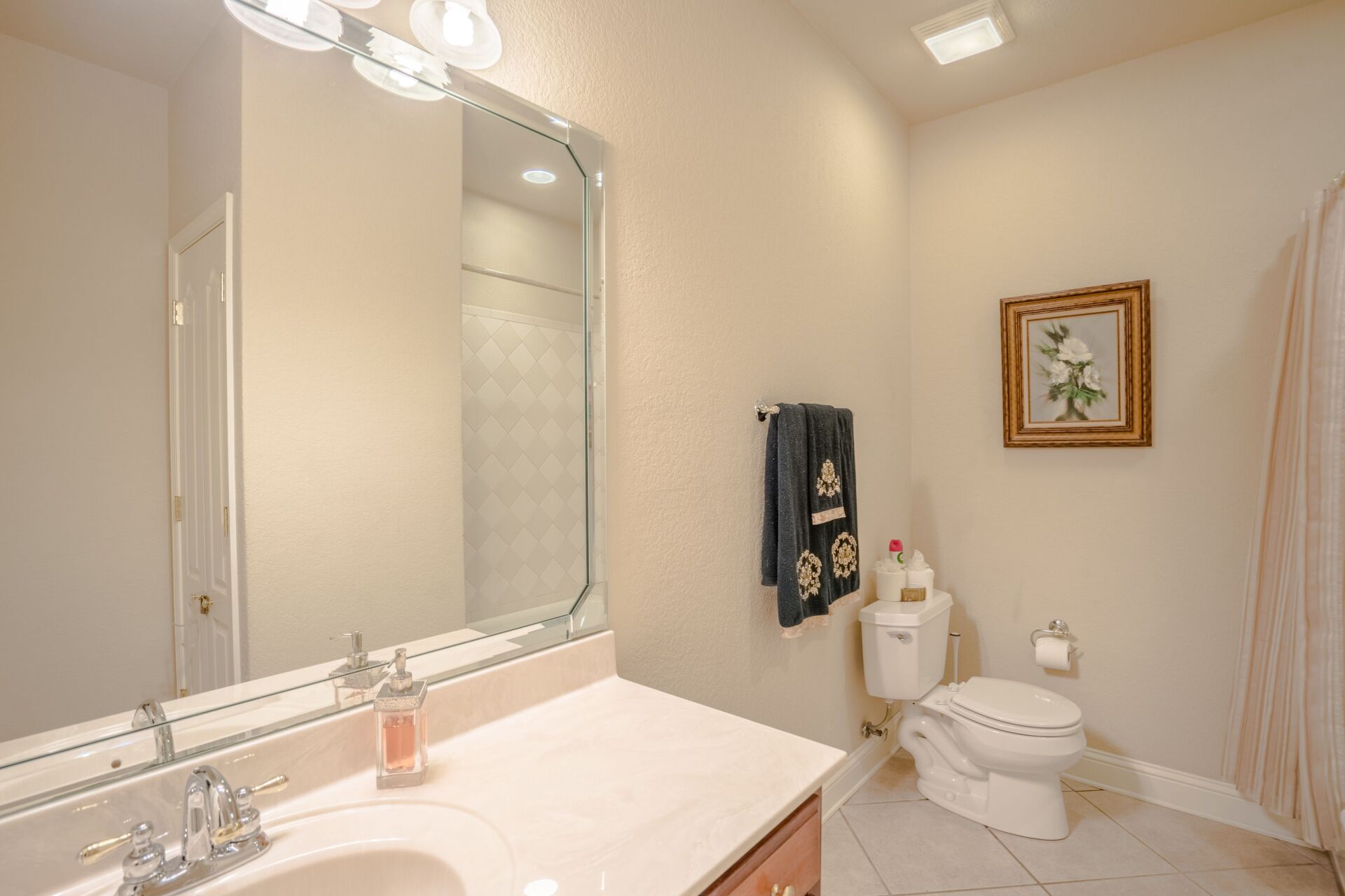 A bathroom with a sink , toilet , and mirror.