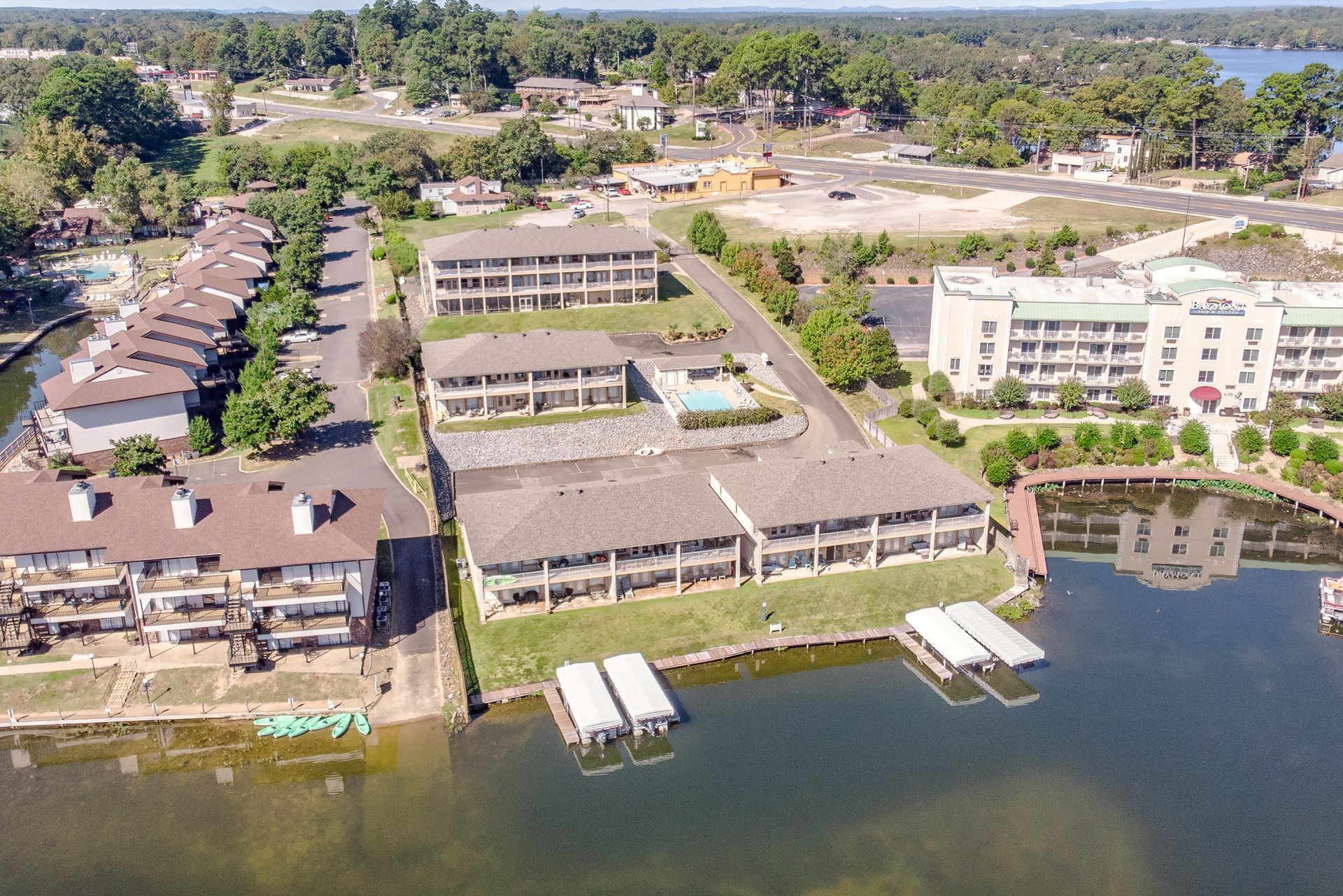 An aerial view of a residential area next to a lake