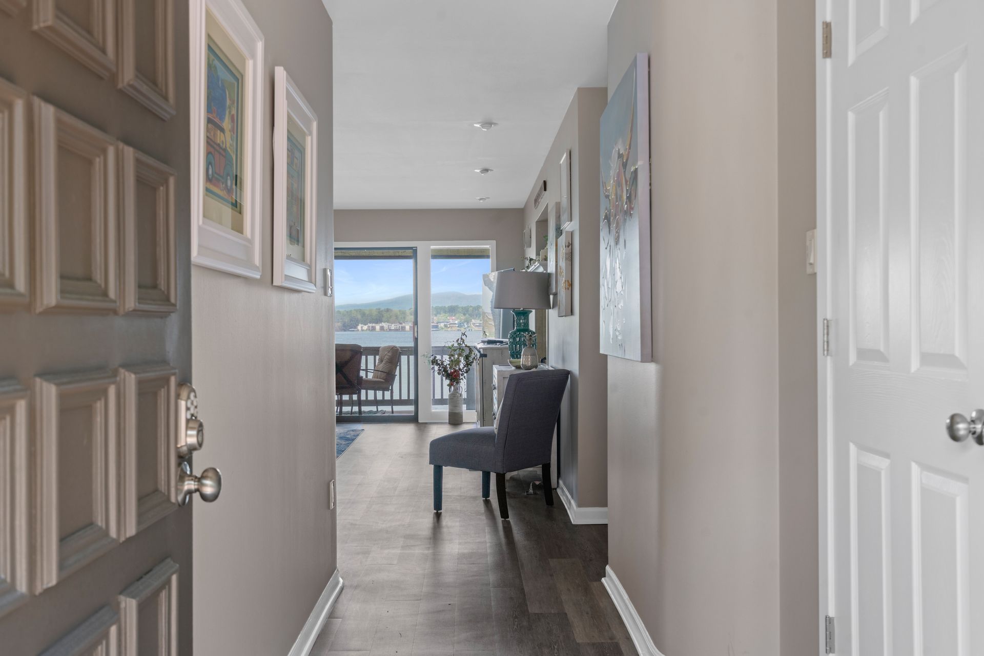 A hallway with a chair and a desk in a house.