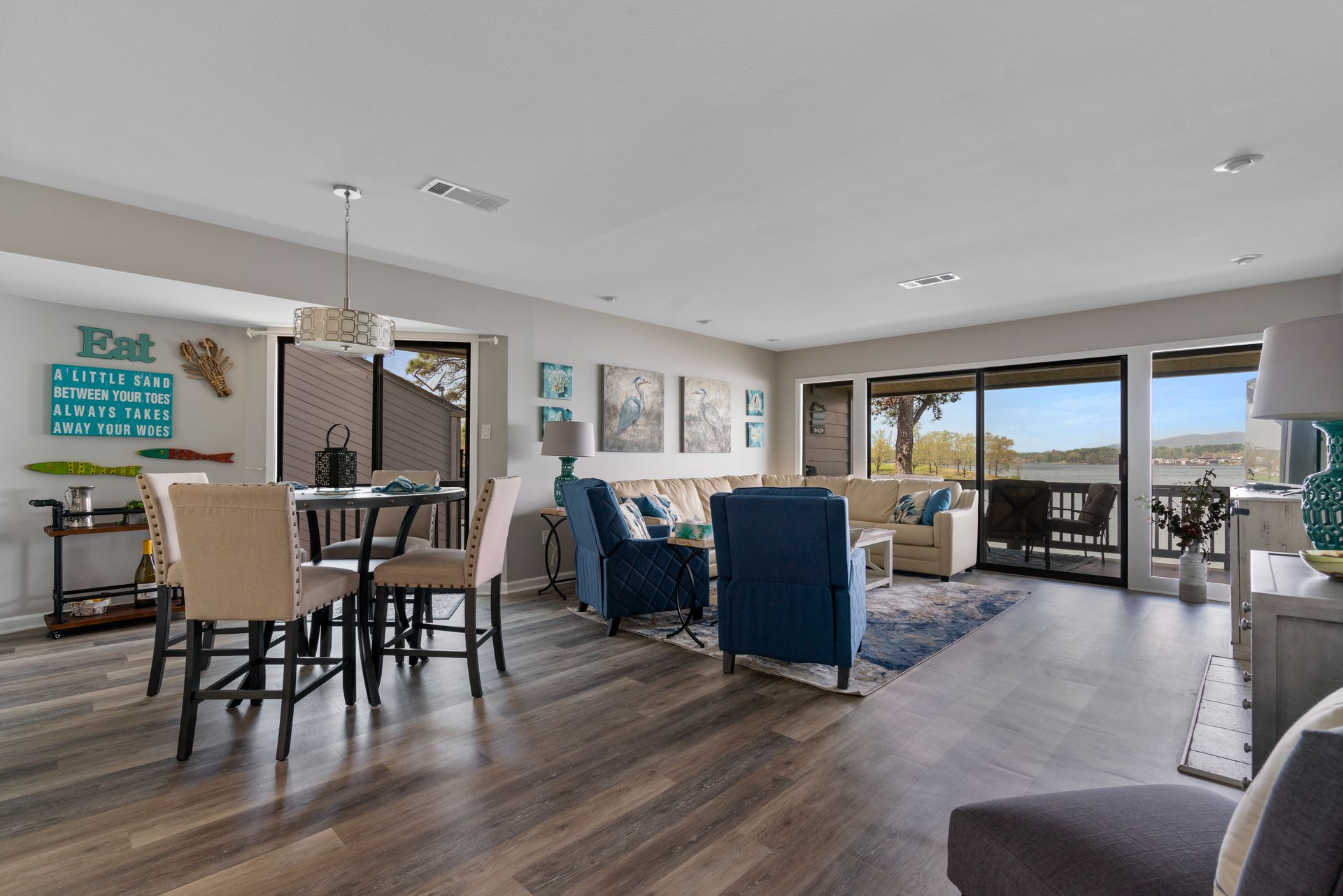 A living room with hardwood floors and a dining table and chairs.