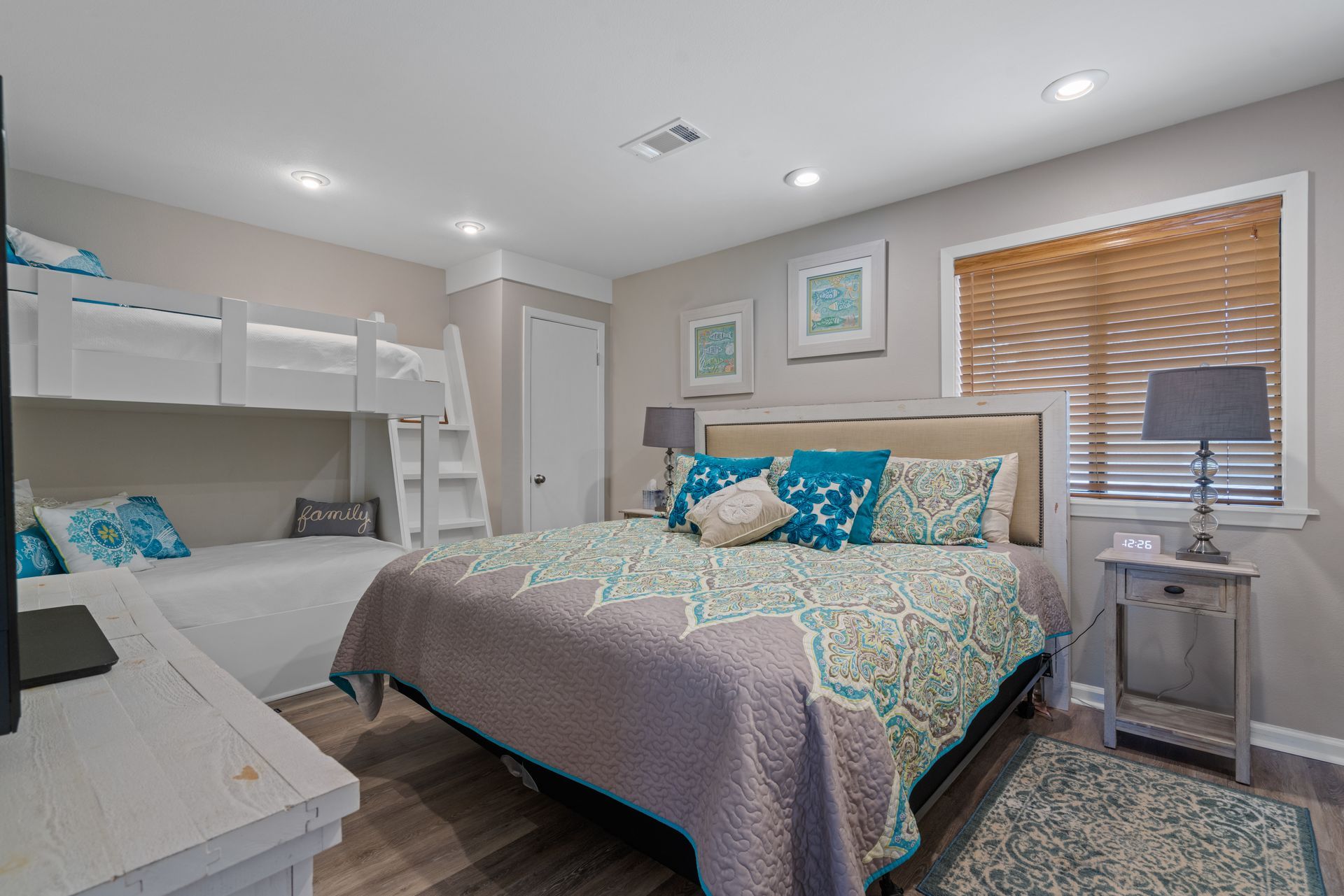 A bedroom with a king size bed and bunk beds.