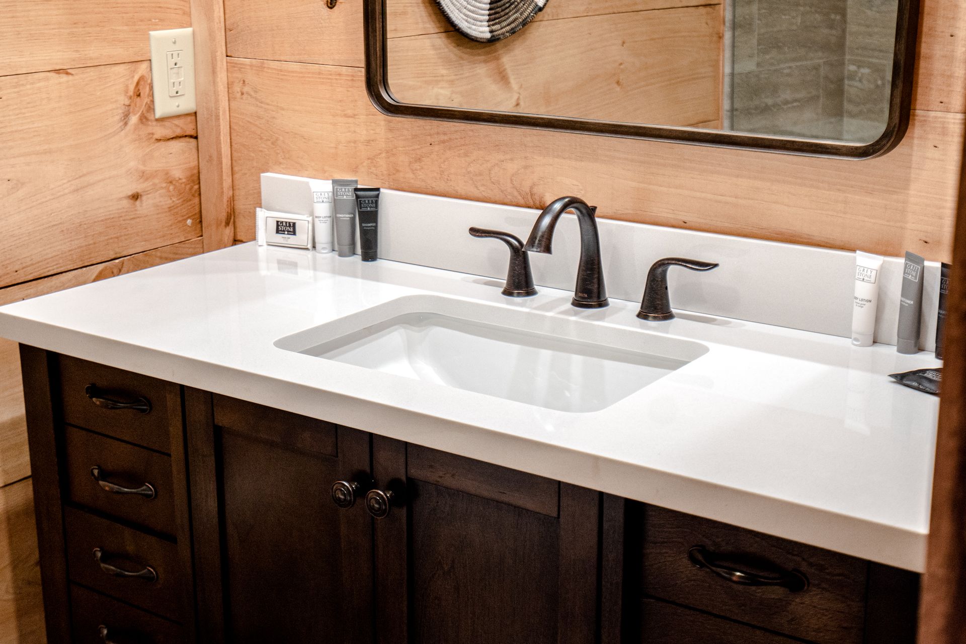 A bathroom vanity with a sink and a mirror.