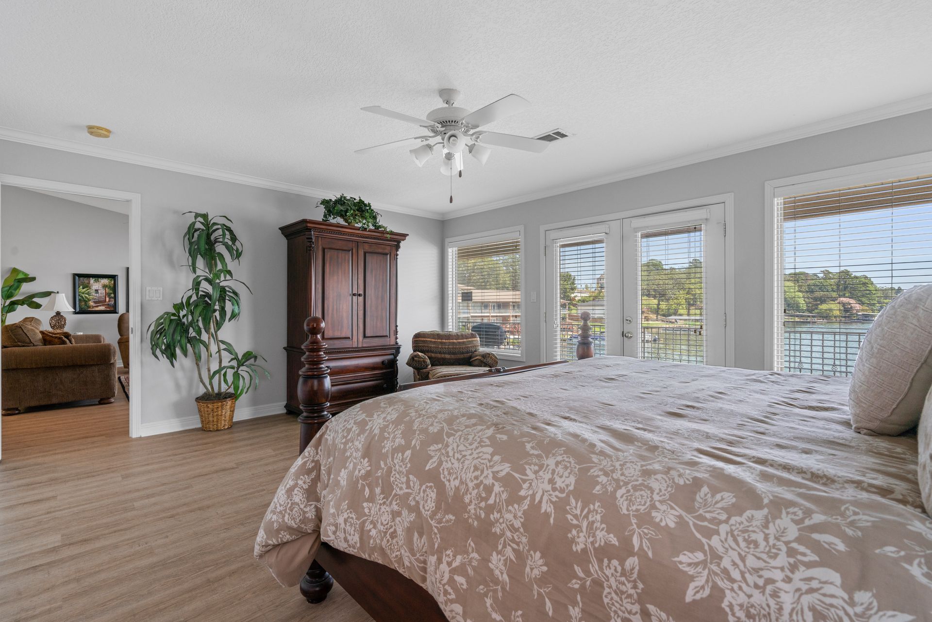 A bedroom with a king size bed and a ceiling fan.