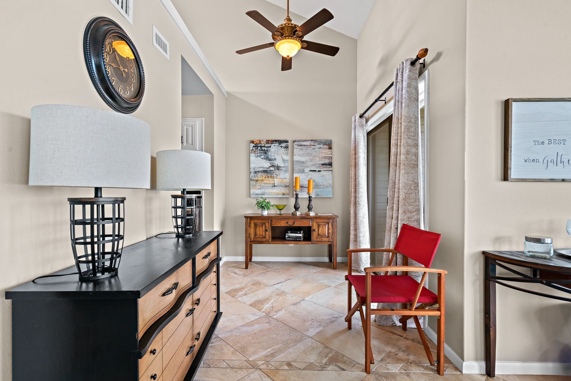 A living room with a ceiling fan and a chair