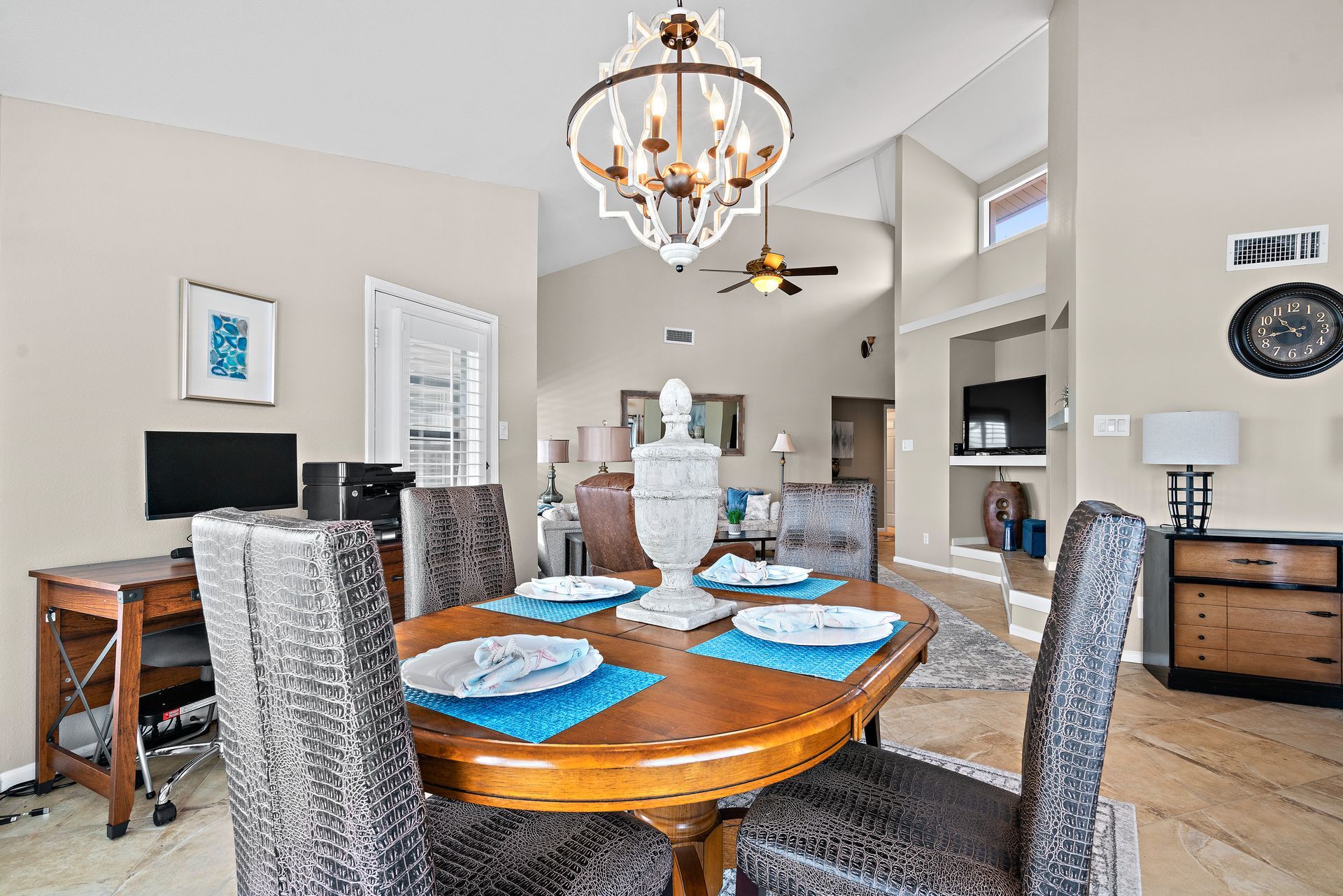 A dining room with a table and chairs and a chandelier.