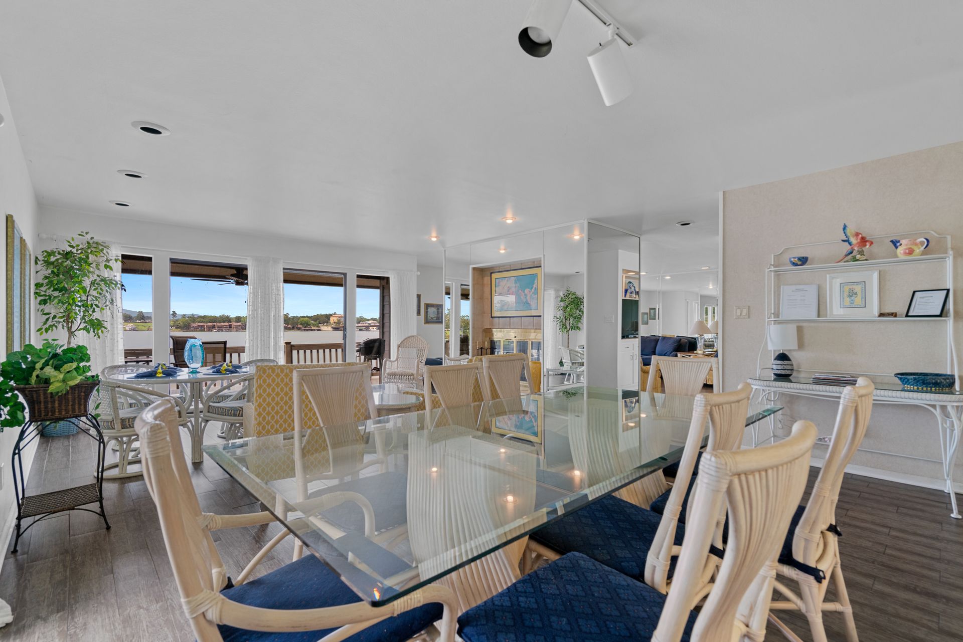 A large dining room with a glass table and chairs.