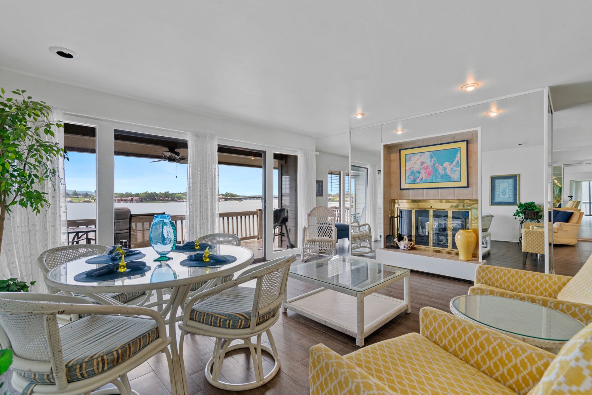 A living room with a table and chairs and a fireplace.
