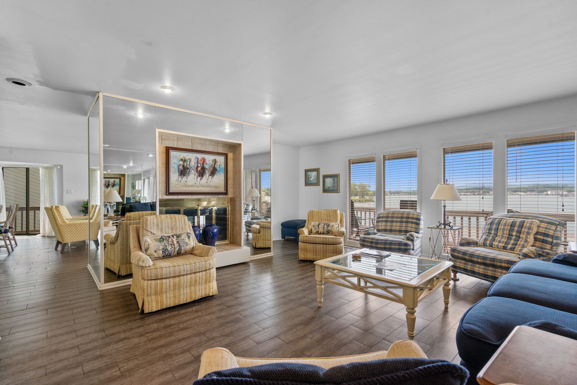 A living room filled with furniture and a large mirror.