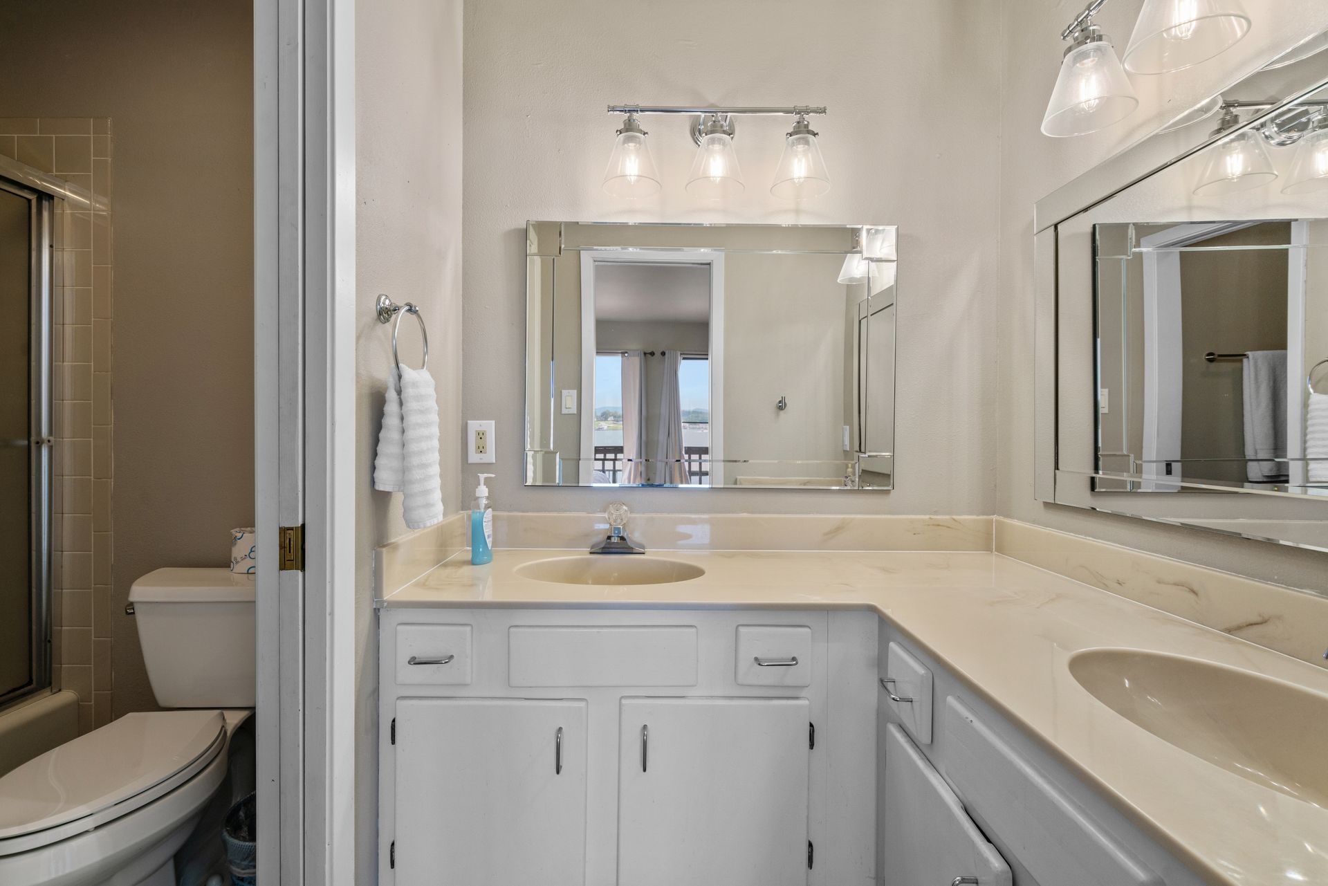 A bathroom with a sink , toilet and mirror.