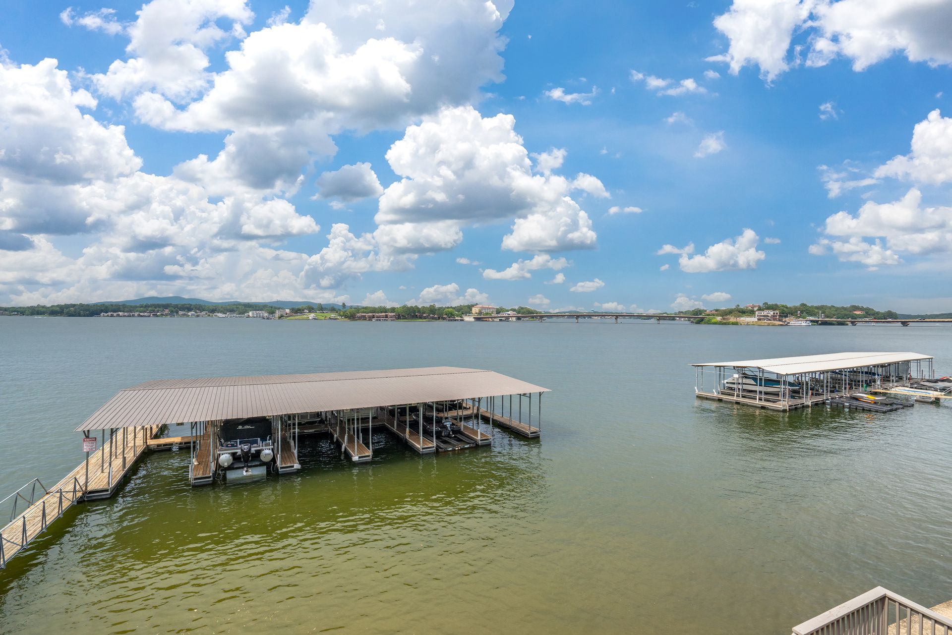 A large body of water with a dock and boats in it.