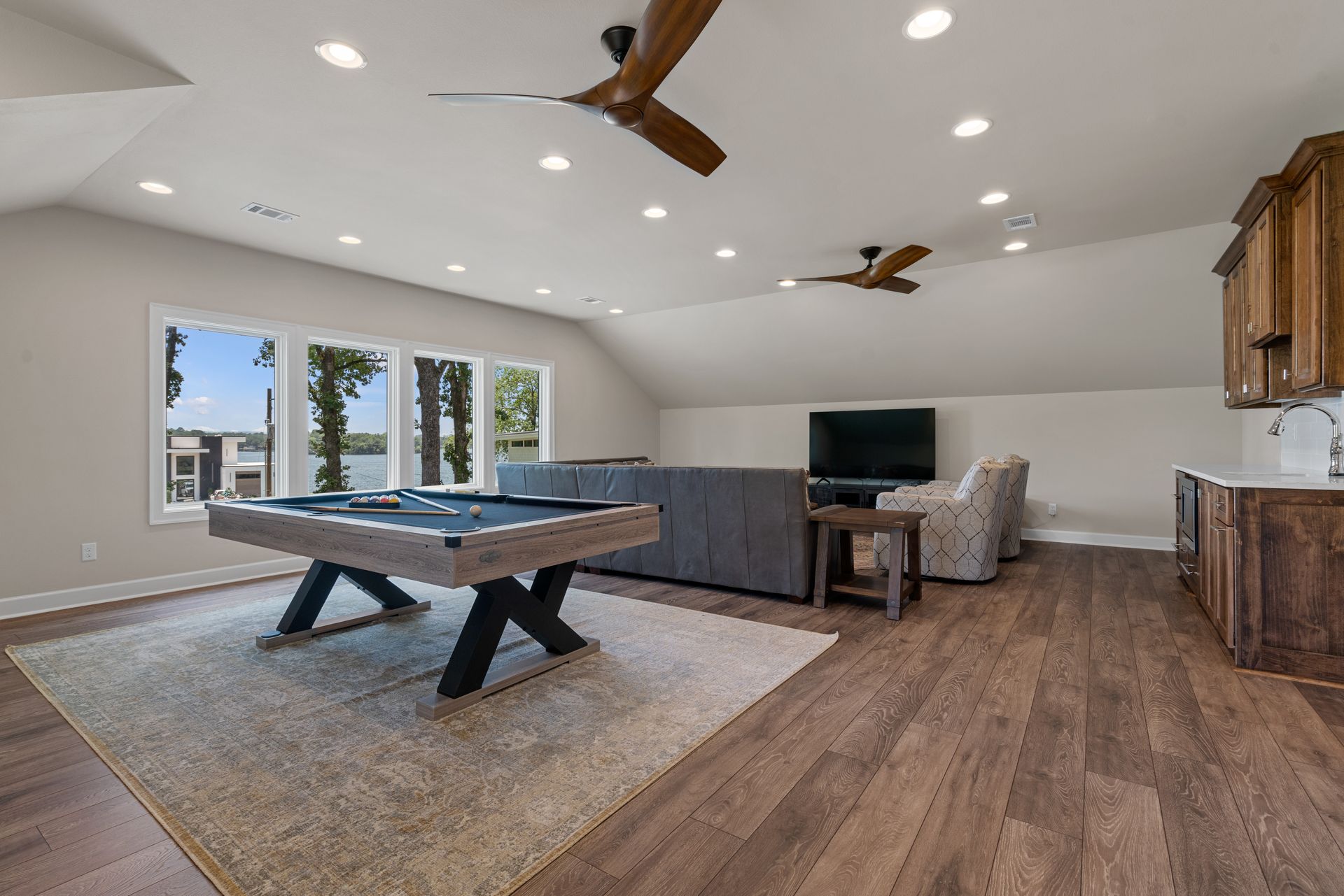 There is a pool table in the middle of the room.