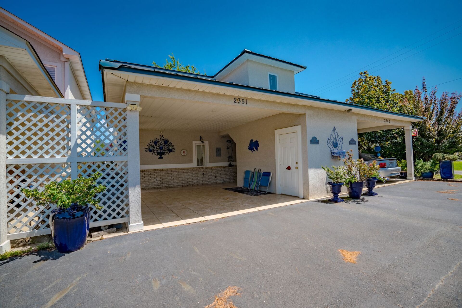 A white house with a carport in front of it