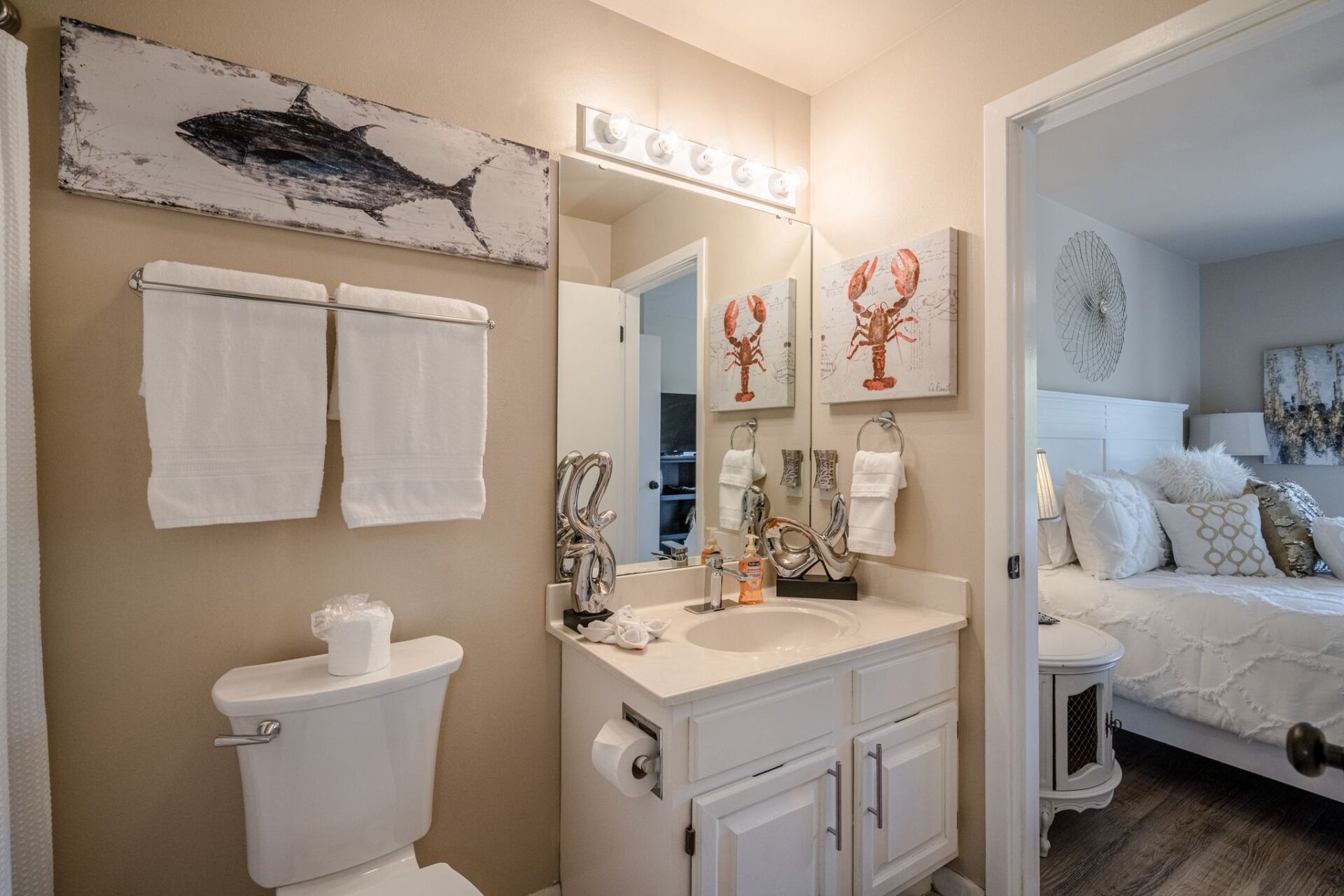 A bathroom with a toilet , sink and mirror.