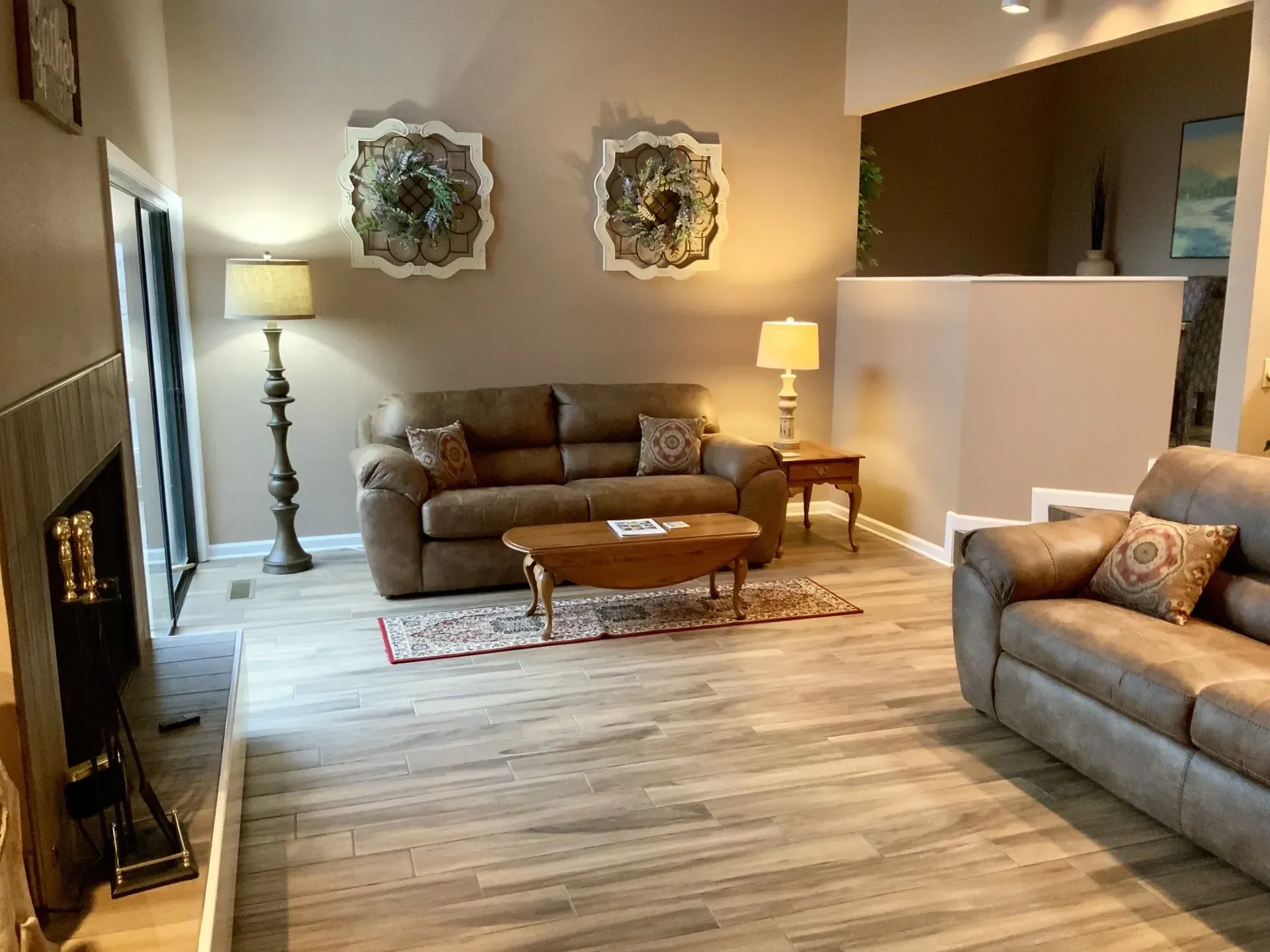 A living room with two couches , a coffee table , and a fireplace.