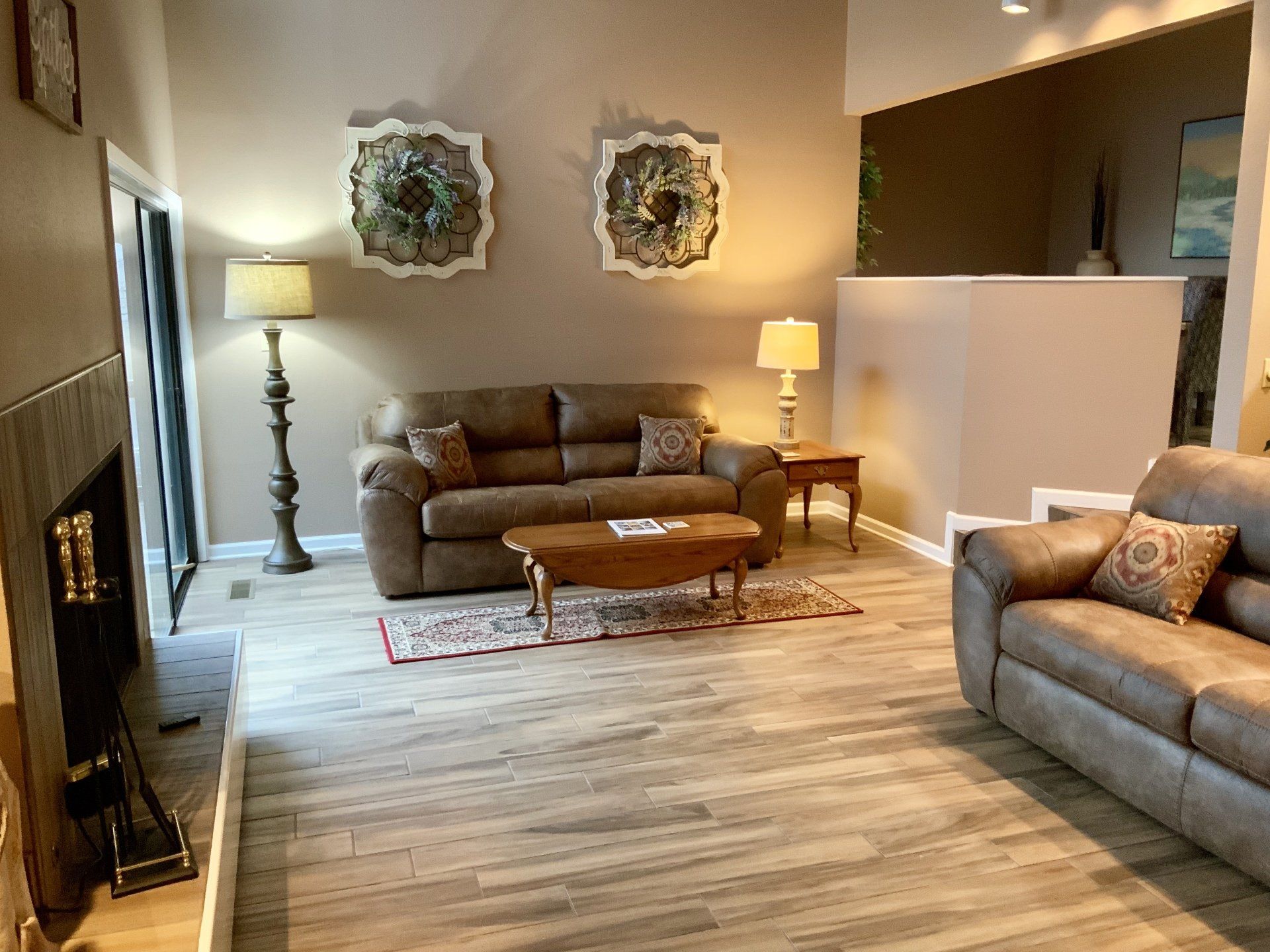 A living room with two couches , a coffee table , and a fireplace.