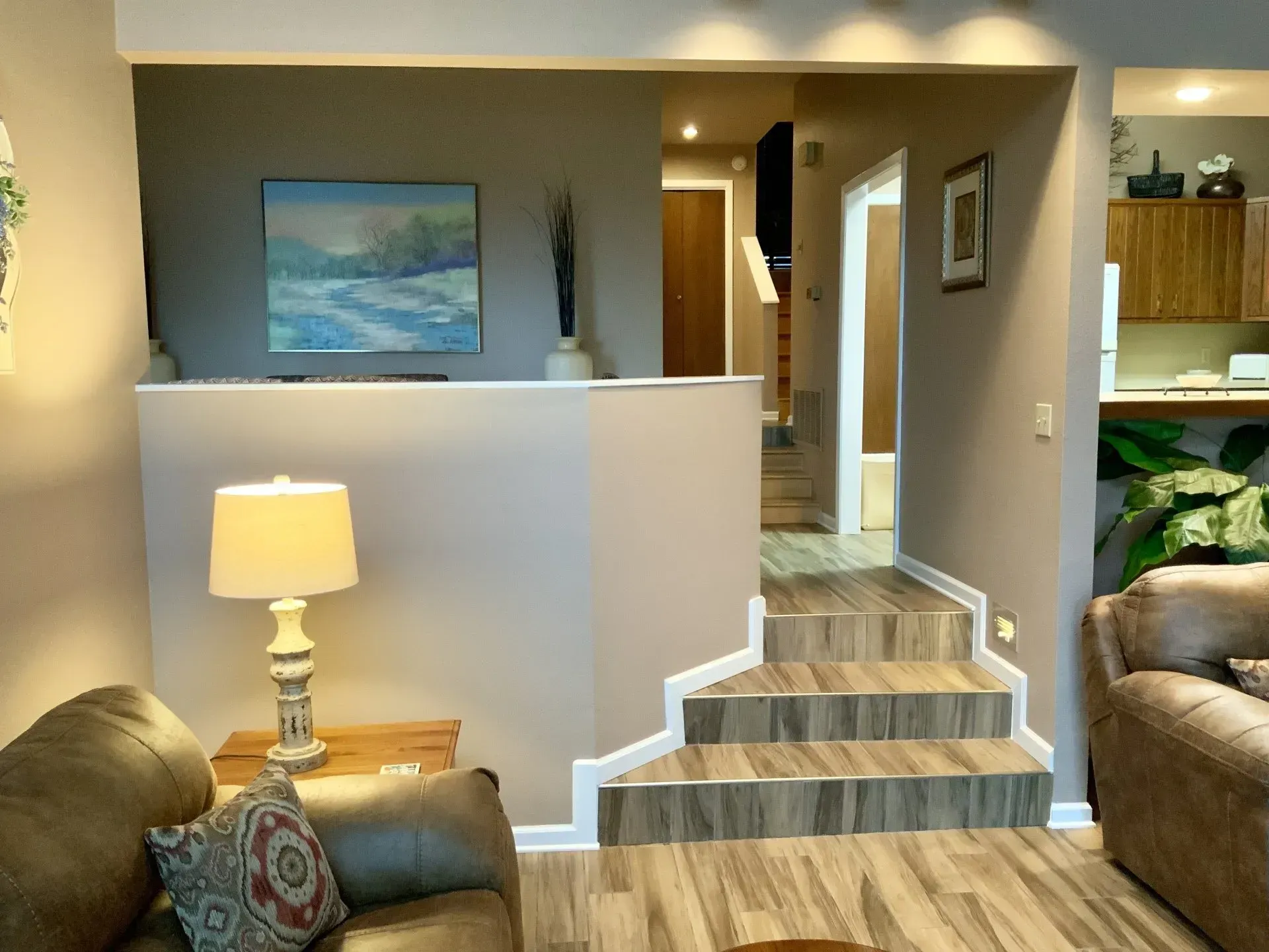 A living room with stairs leading up to the second floor