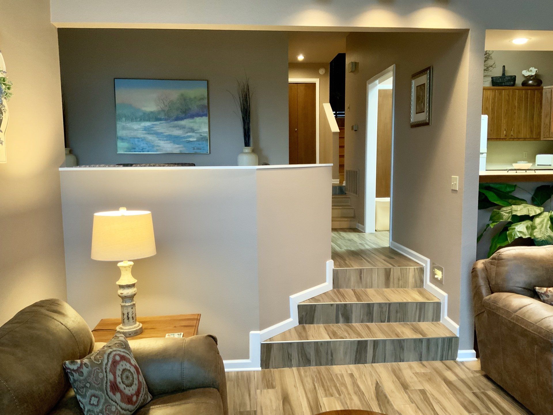 A living room with stairs leading up to the second floor