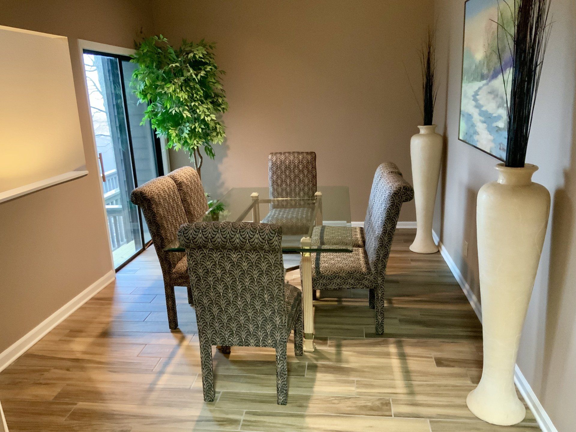 A dining room with a glass table and chairs